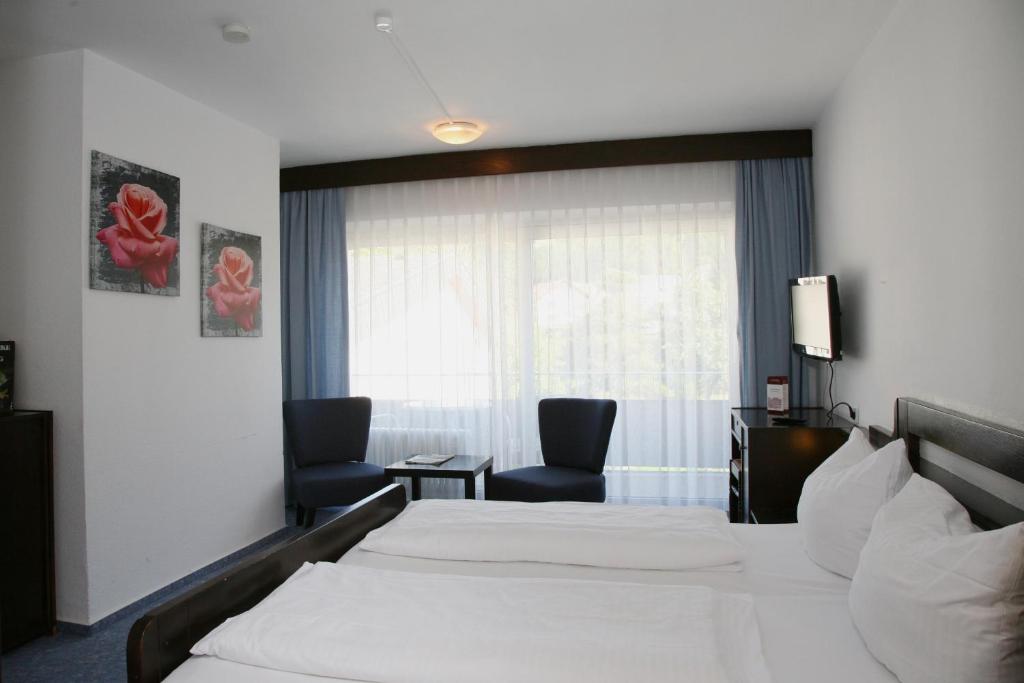 Postel nebo postele na pokoji v ubytování Hotel Pflug