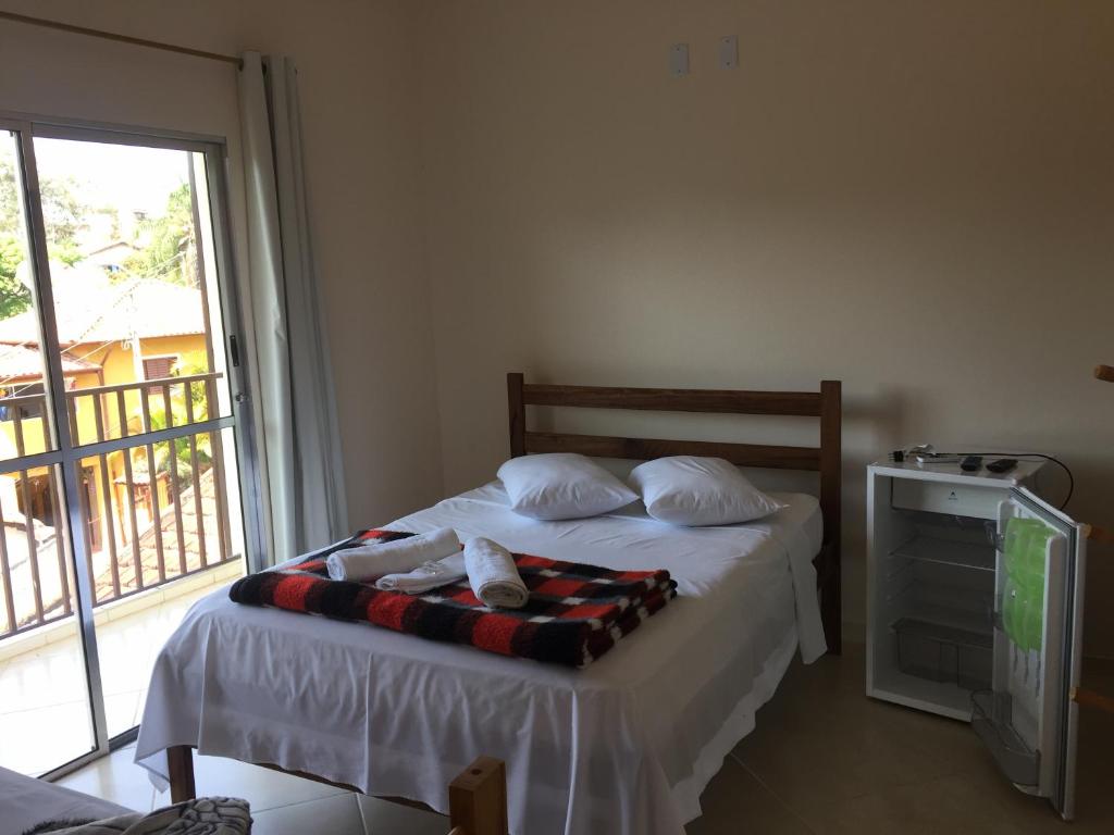 En eller flere senge i et værelse på Hotel Clima da Serra