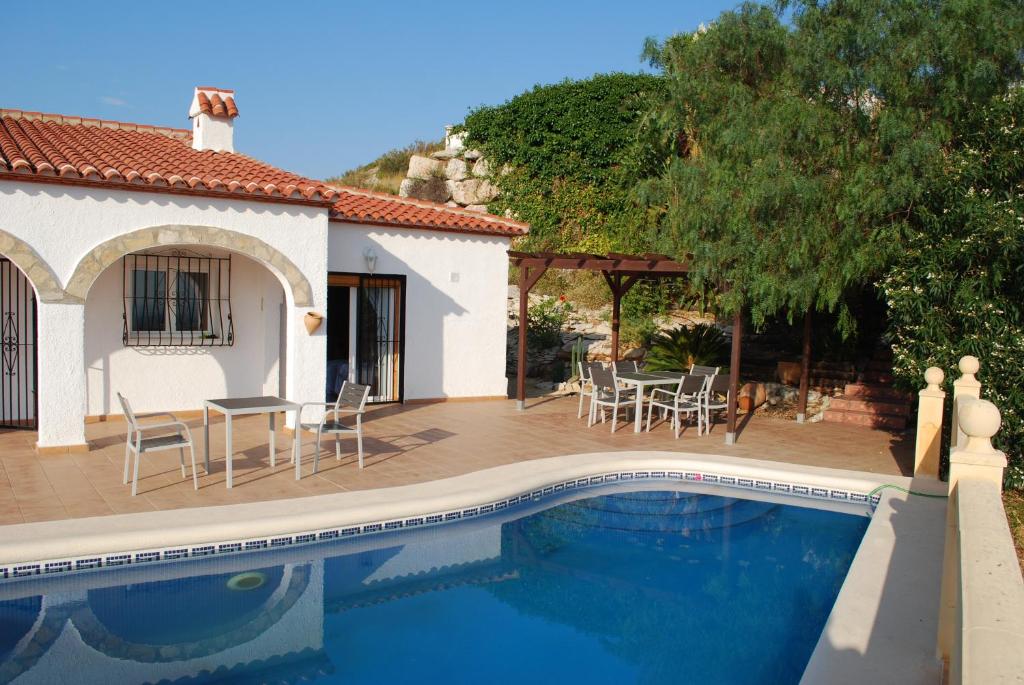 a villa with a swimming pool in front of a house at Villa Bello Horizonte in Pedreguer