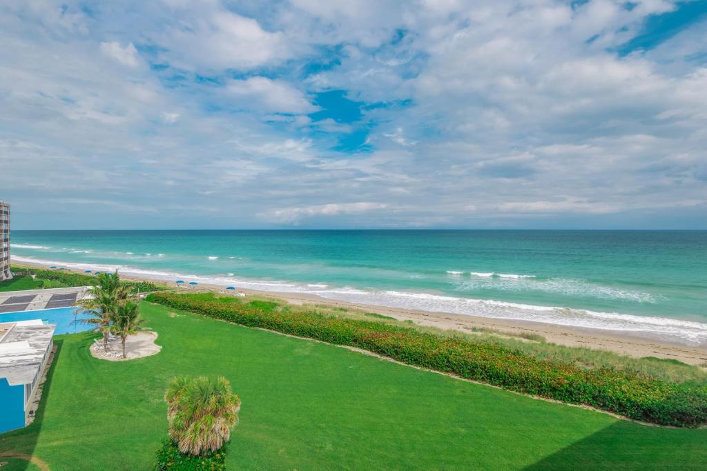 a view of the beach from the balcony of a resort at GetAways at Turtle Reef Club in Jensen Beach