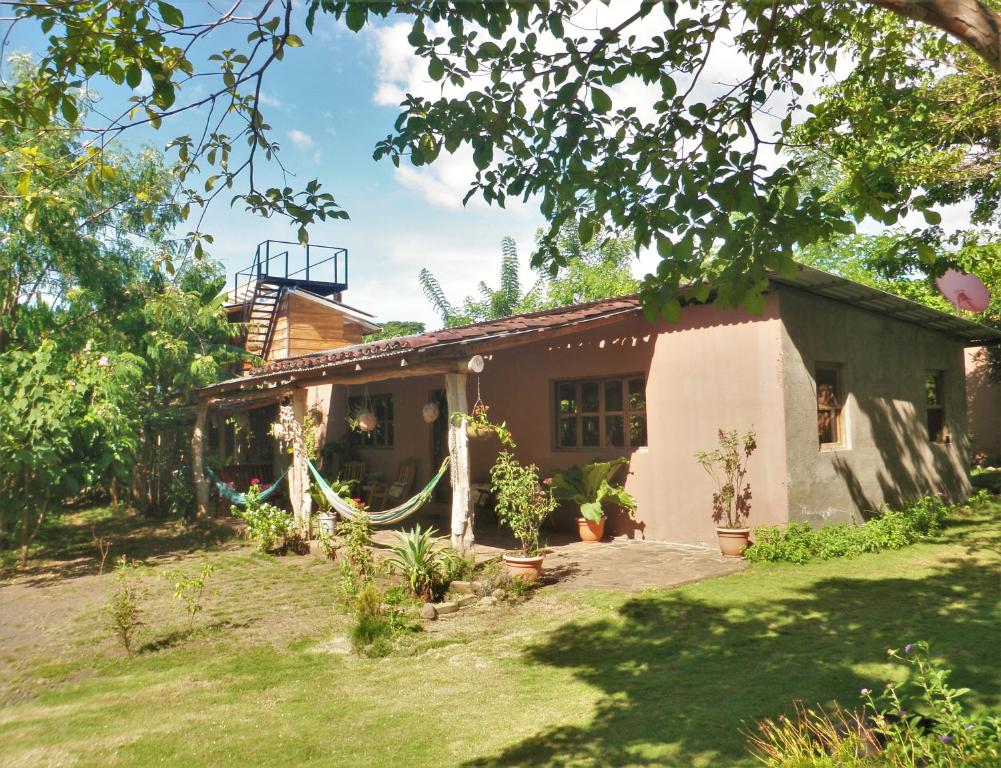 a house with a garden in front of it at Casa Papaki in Mérida