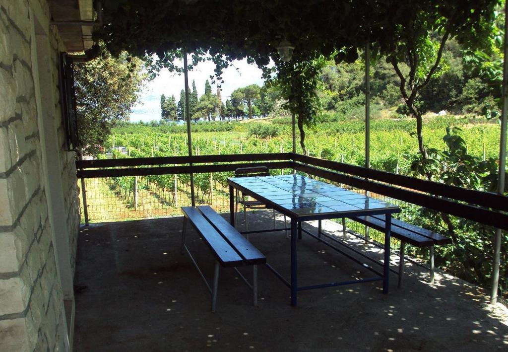 a table and bench with a view of a field at Holiday home Lidija - Robinson House in Postira