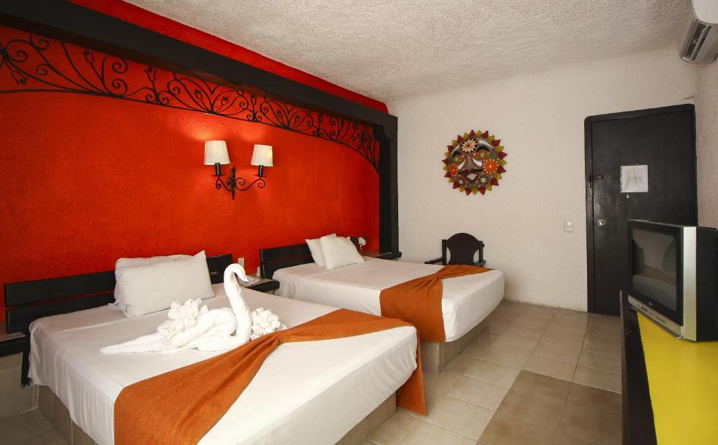 Postel nebo postele na pokoji v ubytování Hotel Xbalamqué & Spa Cancún Centro