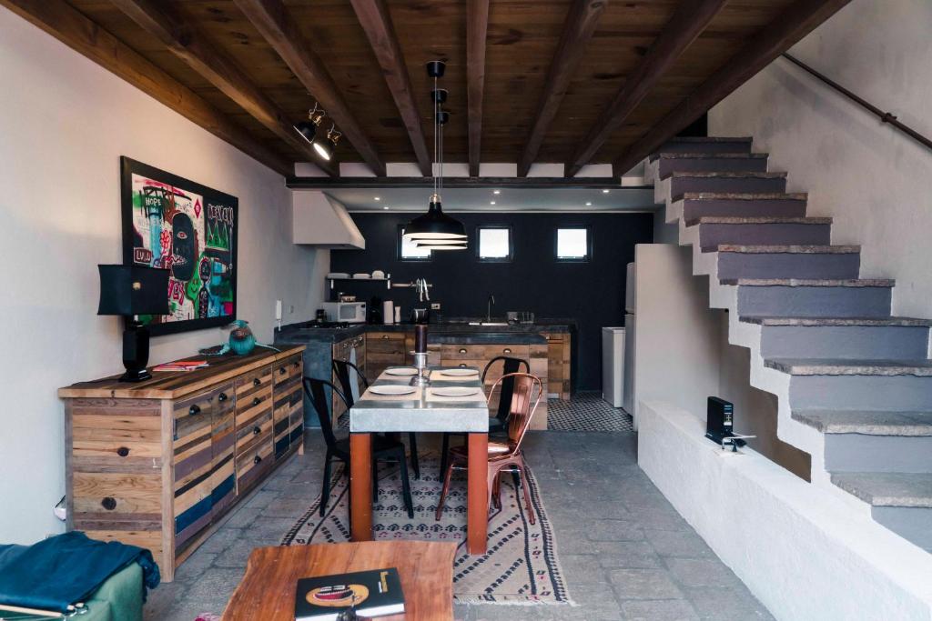 a dining room with a table and some stairs at Canela Fina - Adults Only in San Miguel de Allende