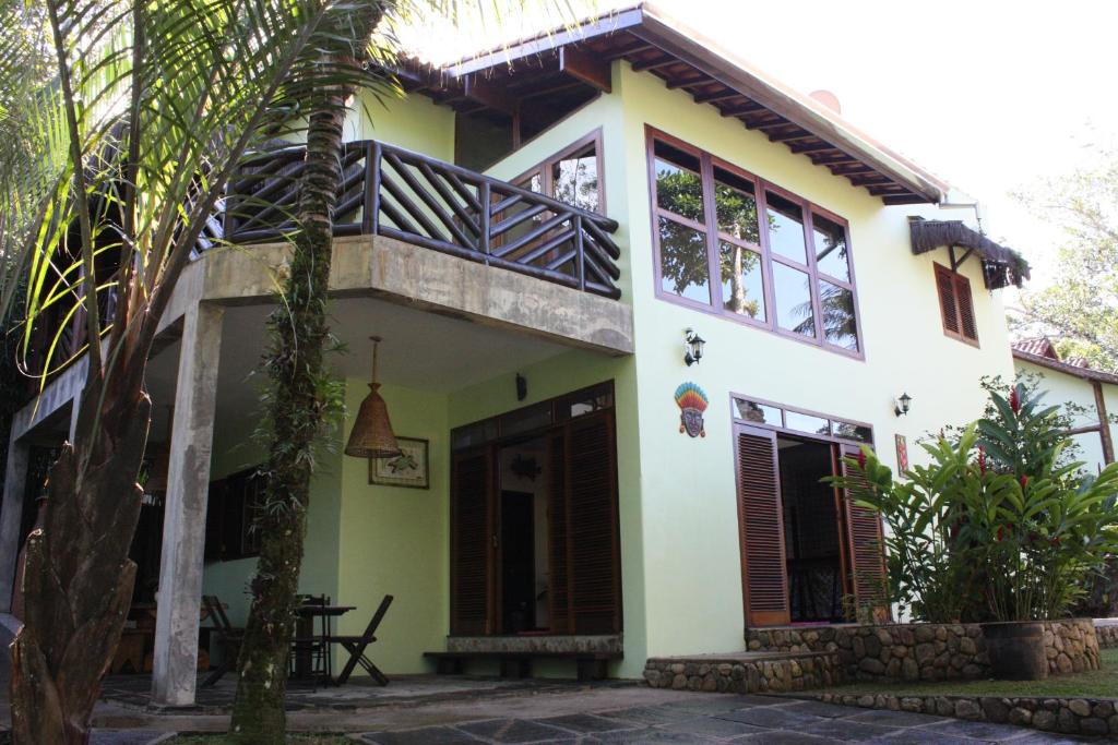 uma casa com uma varanda ao lado em Recanto Tangara - Casa - Praia do Felix em Ubatuba