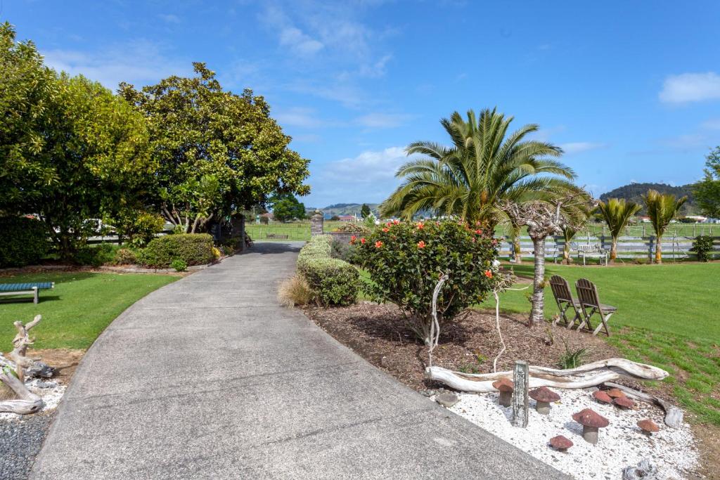 a walkway in a park with trees and bushes at Breakaway Bed & Breakfast in Coromandel Town