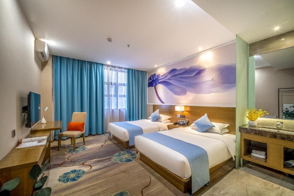 Postel nebo postele na pokoji v ubytování Zhongshan Bafei Hotel