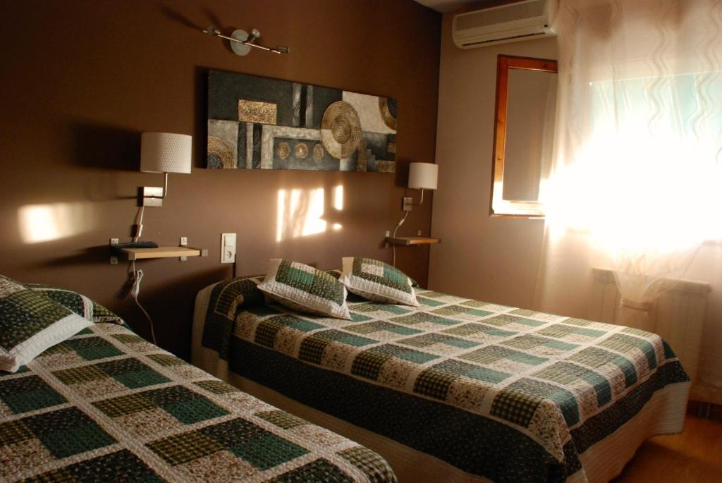 Postel nebo postele na pokoji v ubytování Hostal Delgado