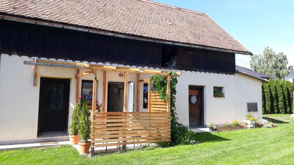 a small white house with a black roof at Apartment 1 in Hrabušice