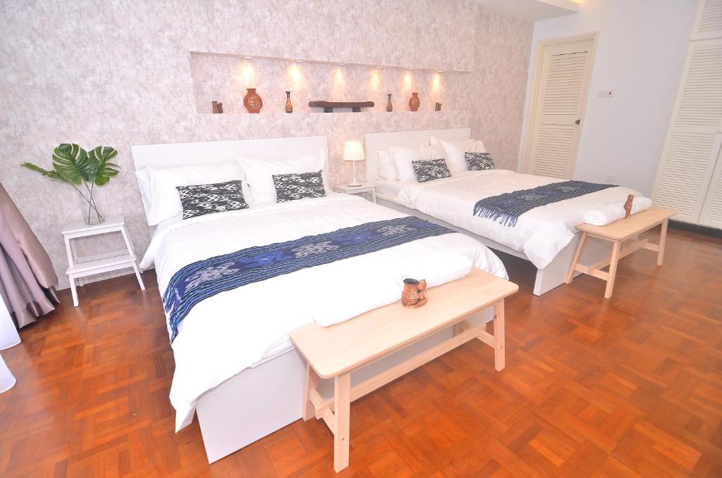 เตียงในห้องที่ New Riverbank Suites - Waterfront Kuching City