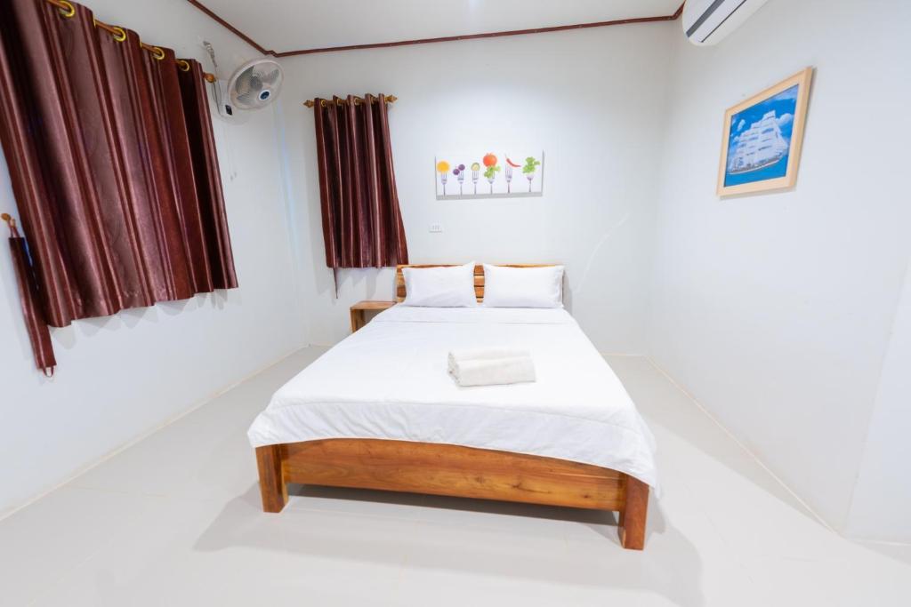 Postel nebo postele na pokoji v ubytování Khun Ning Resort