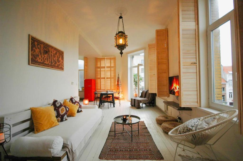 a living room with a couch and a fireplace at SLEEP INN - 1001 Nights Loft Citycenter with Balconyview in Antwerp