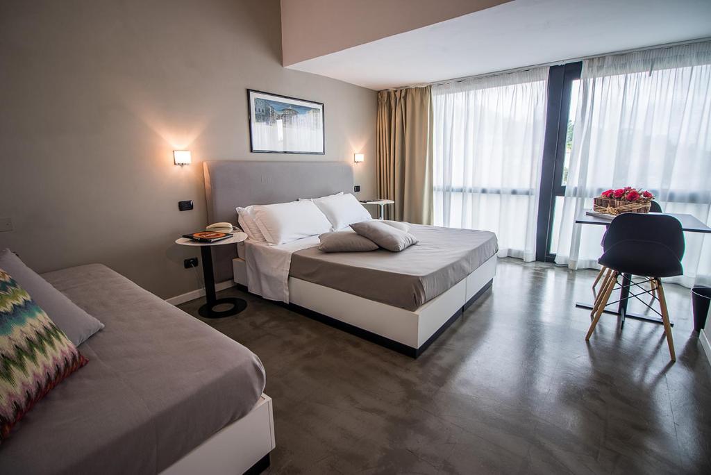 Postel nebo postele na pokoji v ubytování Hotel Clarici