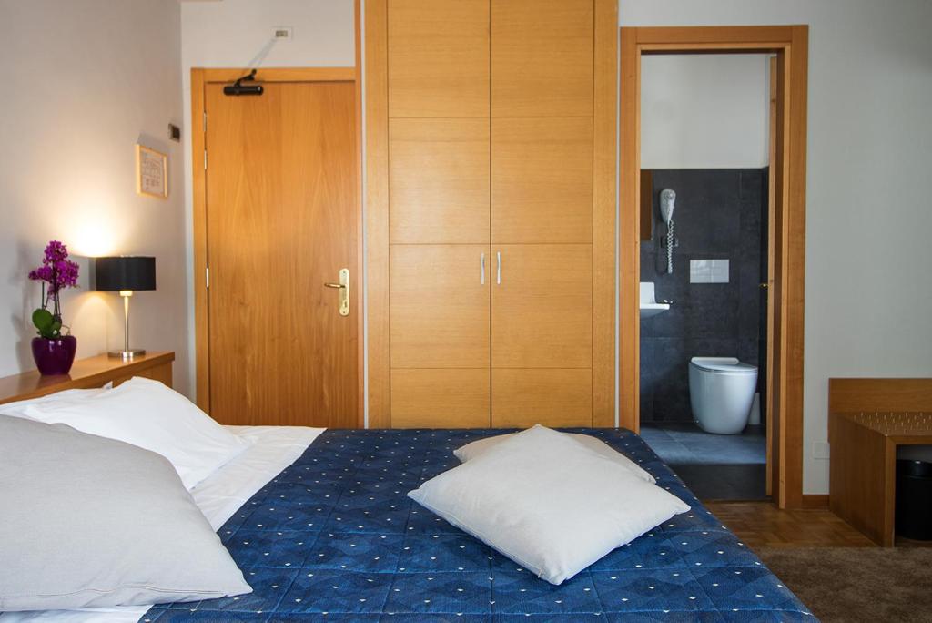 Postel nebo postele na pokoji v ubytování Hotel Clarici
