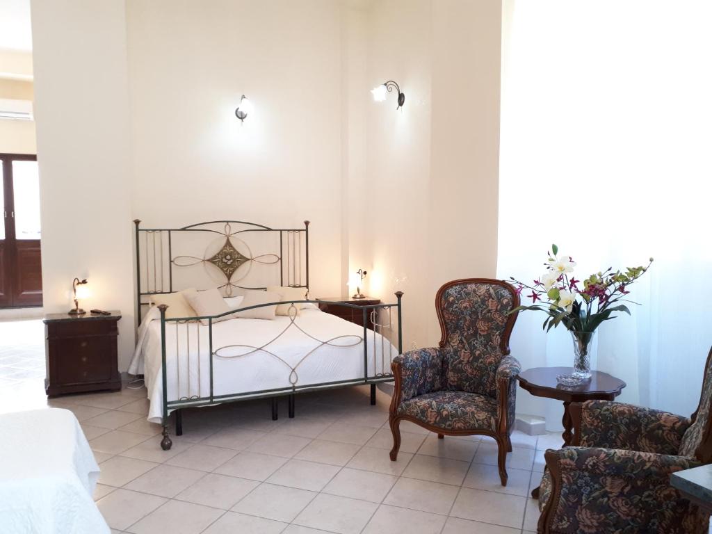 a bedroom with a bed and a chair at Casa Mia Apartment in Riposto