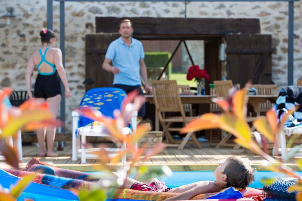 a group of people in a swimming pool at Gîte de La Jéraphie in La Souterraine