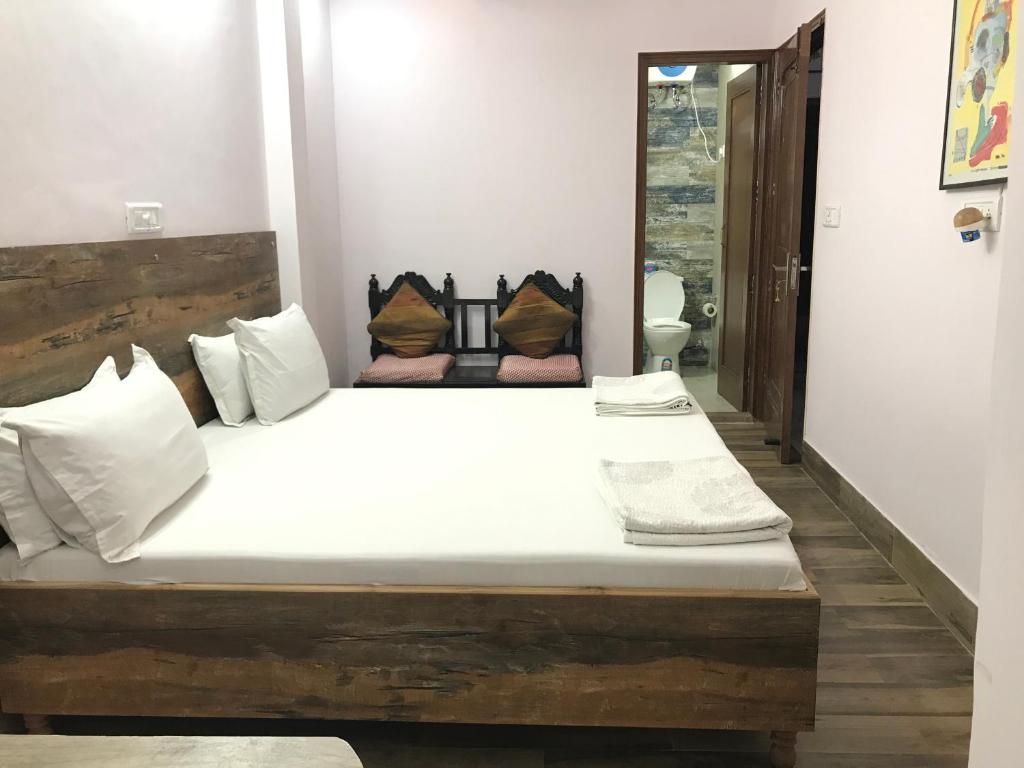 Postel nebo postele na pokoji v ubytování Tatvamasi Homestay