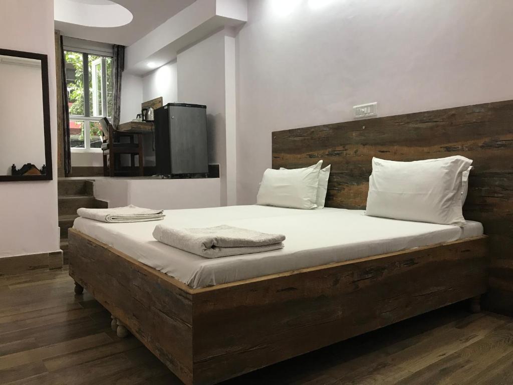 Postel nebo postele na pokoji v ubytování Tatvamasi Homestay