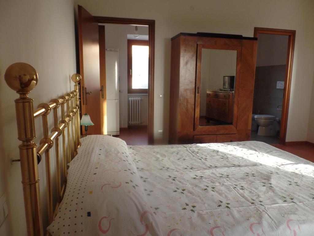 a bedroom with a large bed and a bathroom at Appartamento in Villa Santa Caterina in Frascati