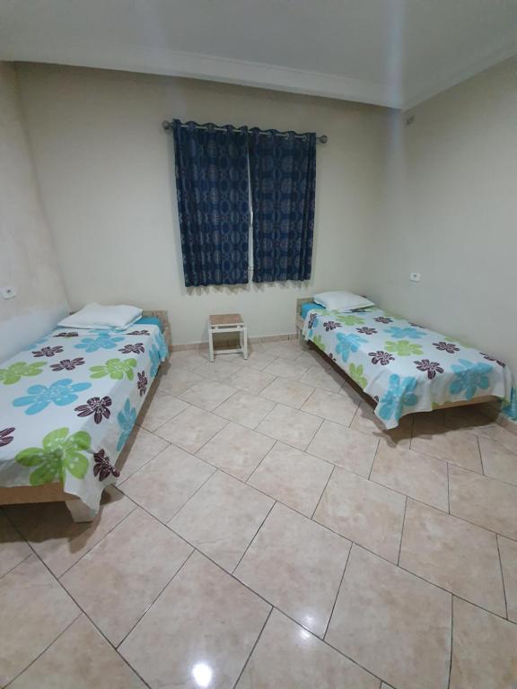 Una cama o camas en una habitación de Hotel Afef