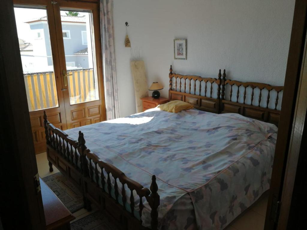 a bedroom with a large bed with a blue comforter at Casa Henni in Els Poblets