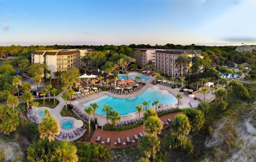 a scenic view of a beach with palm trees at Omni Hilton Head Oceanfront Resort in Hilton Head Island
