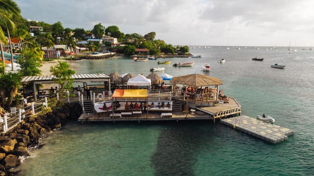 una vista aerea su un molo con un ristorante sull'acqua di Hotel-Restaurant La Dunette a Sainte-Anne