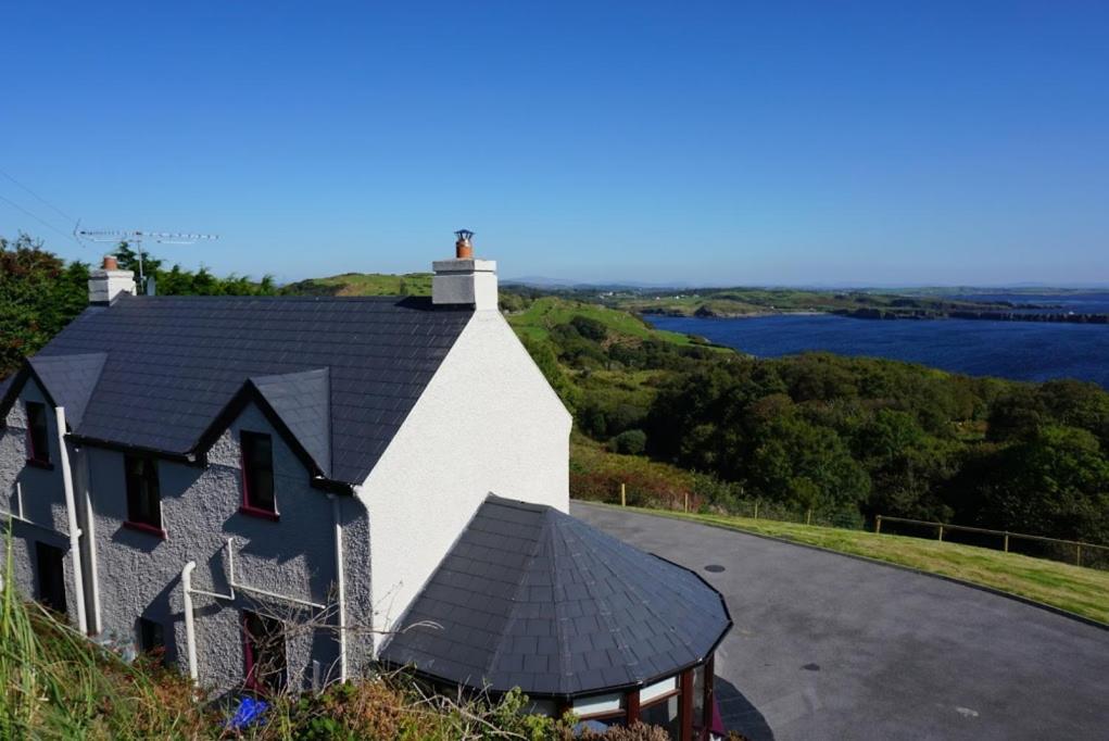 a house on a hill with a view of the water at Lighthouse Cottage in Donegal