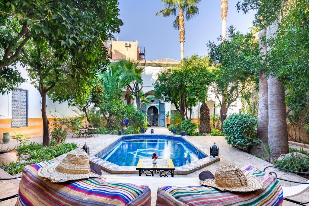 a swimming pool with lounge chairs and a resort at Riad Laila in Marrakech