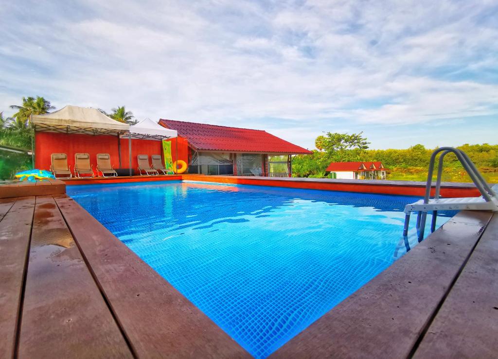 a swimming pool in front of a house at Anissa Resort Koh Yao Yai in Ko Yao Yai