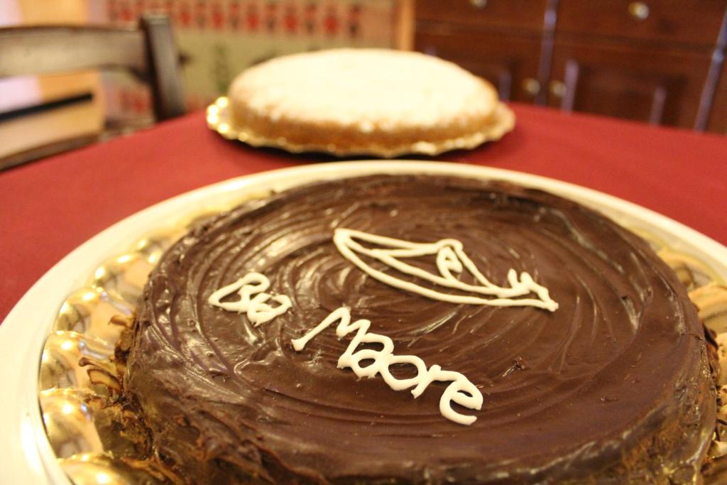 a chocolate cake on a plate on a table at Hotel Bia Maore in Baunei