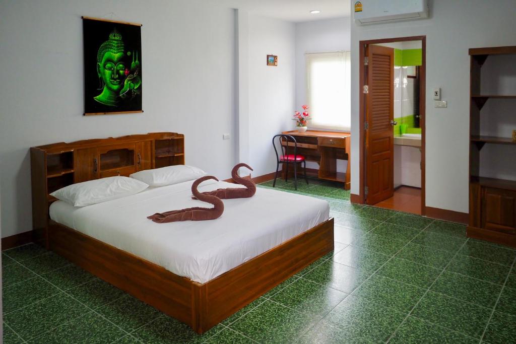a bedroom with a bed with a snake on it at Jardin in Pattaya South
