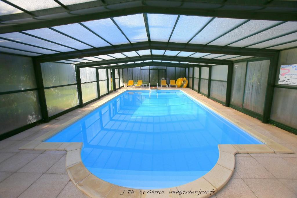 a large swimming pool in a building at Locatlantique in Aytré