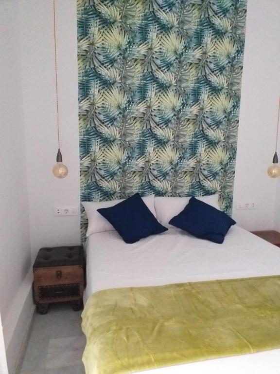 Postel nebo postele na pokoji v ubytování WISH SUITE SAN LUIS DE SEVILLA