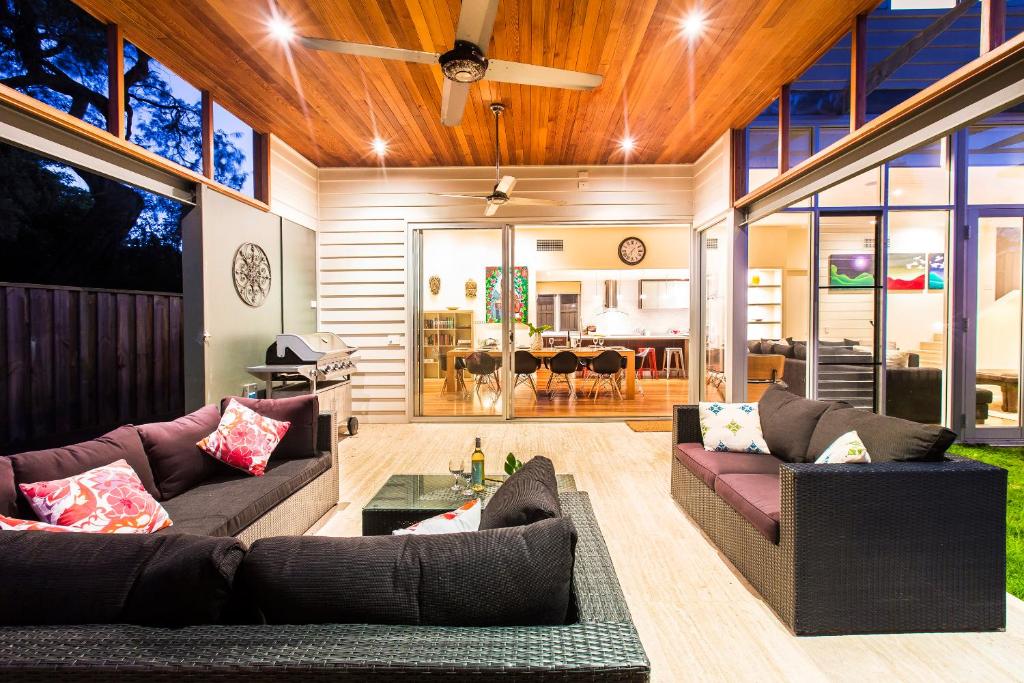 a living room with two couches and a dining room at Arthouse, beach 200m, kids TV area, air-con in Dunsborough