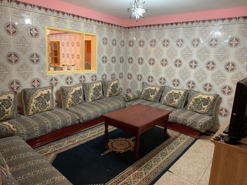 a living room with a couch and a table at Quiet Apartment in El Ksiba / Beni Mellal in El Ksiba