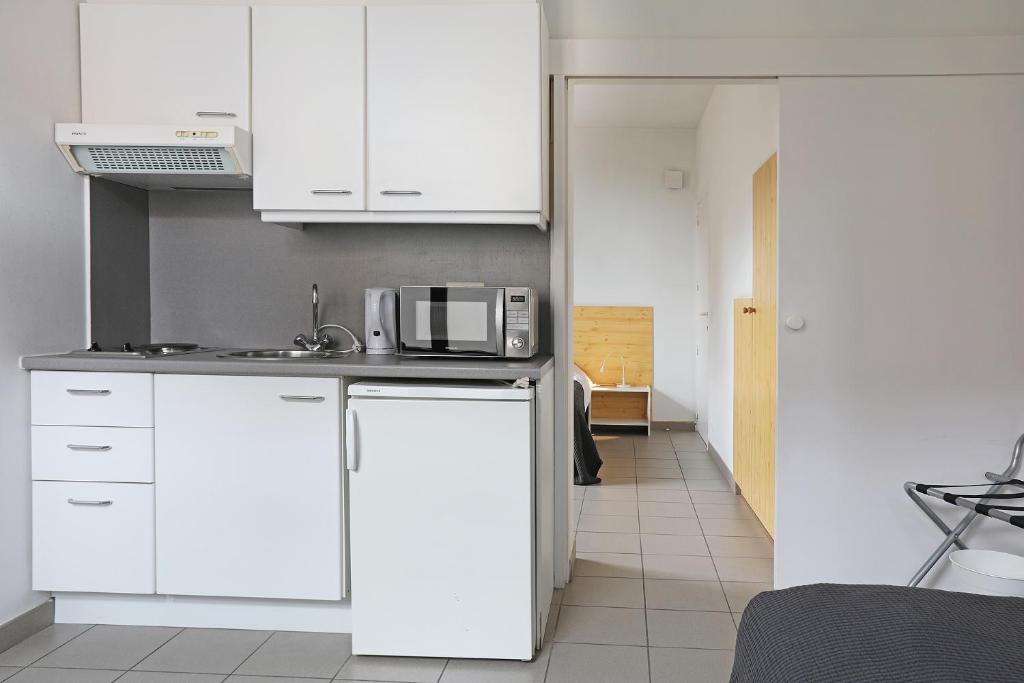 Kuchyň nebo kuchyňský kout v ubytování Hotel De Loft