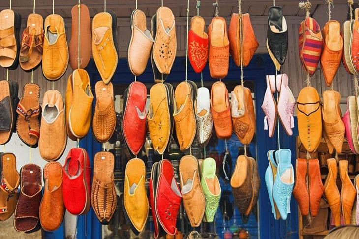 a bunch of shoes are hanging on a wall at Apartment Monte Cristo in Casablanca