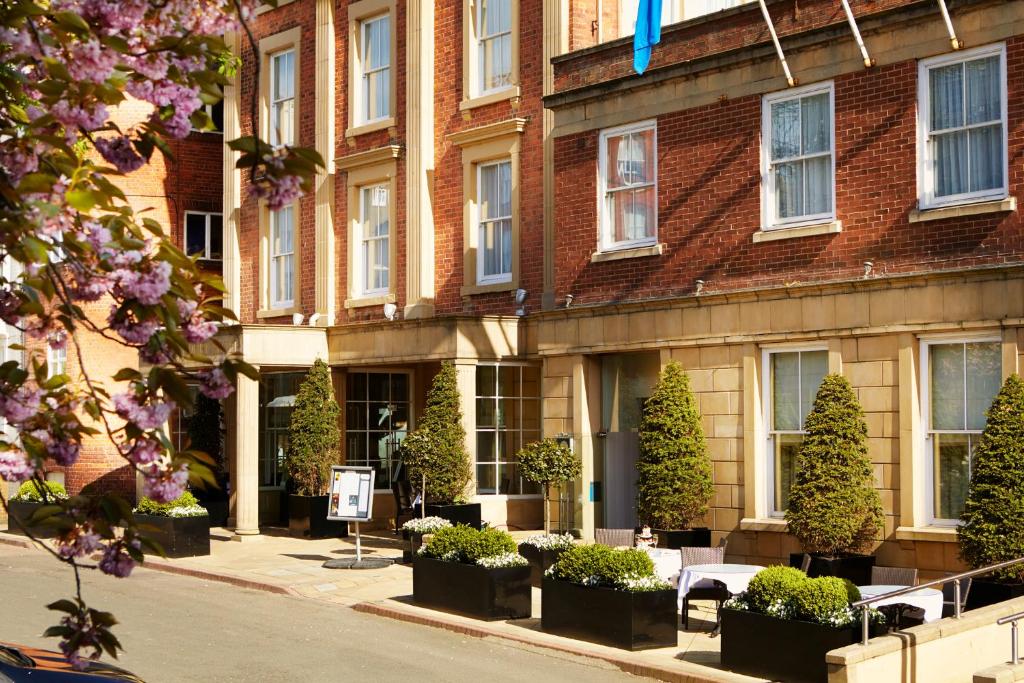 a building with a bunch of plants in front of it at Palm Court Hotel in Scarborough