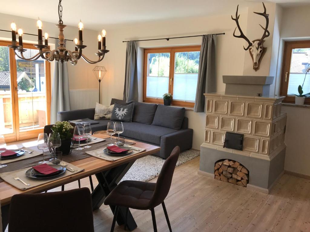 a living room with a table and a fireplace at Apartment Streifblick in Reith bei Kitzbühel