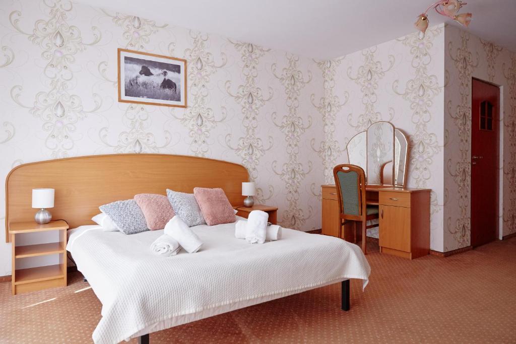En eller flere senge i et værelse på Pensjonat Wioletta