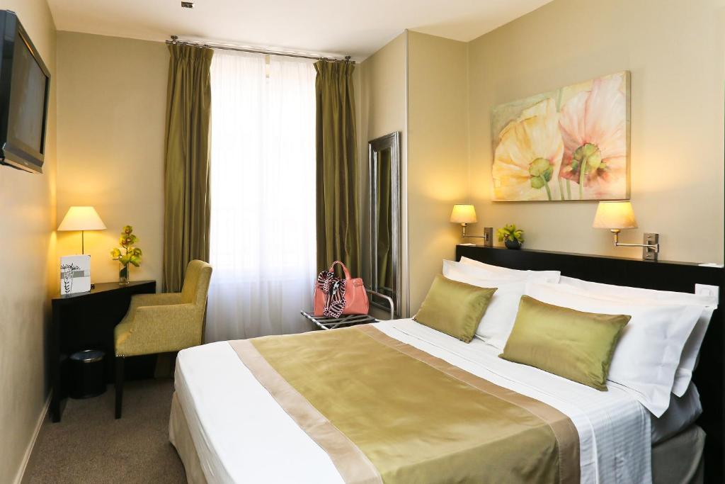 a hotel room with a large bed and a window at La Place Boutique Hotel in Antibes