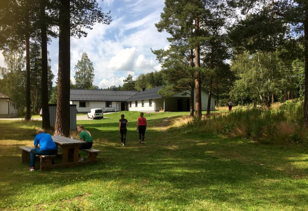 a group of people sitting at a picnic table in a park at Torpomoen in Torpo