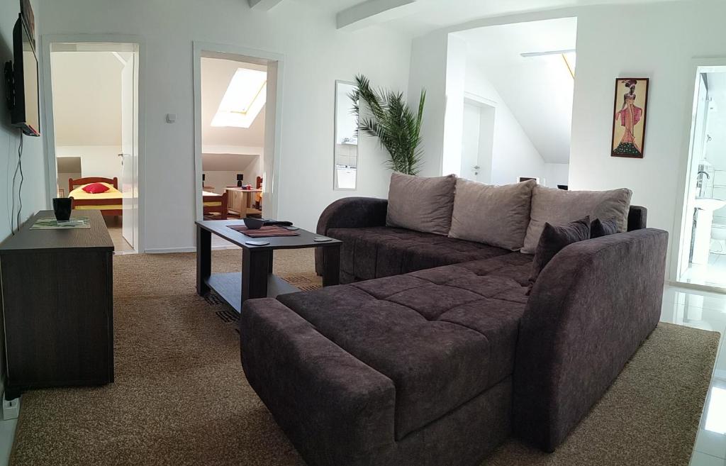 a living room with a couch and a table at BC Apartments in Niš