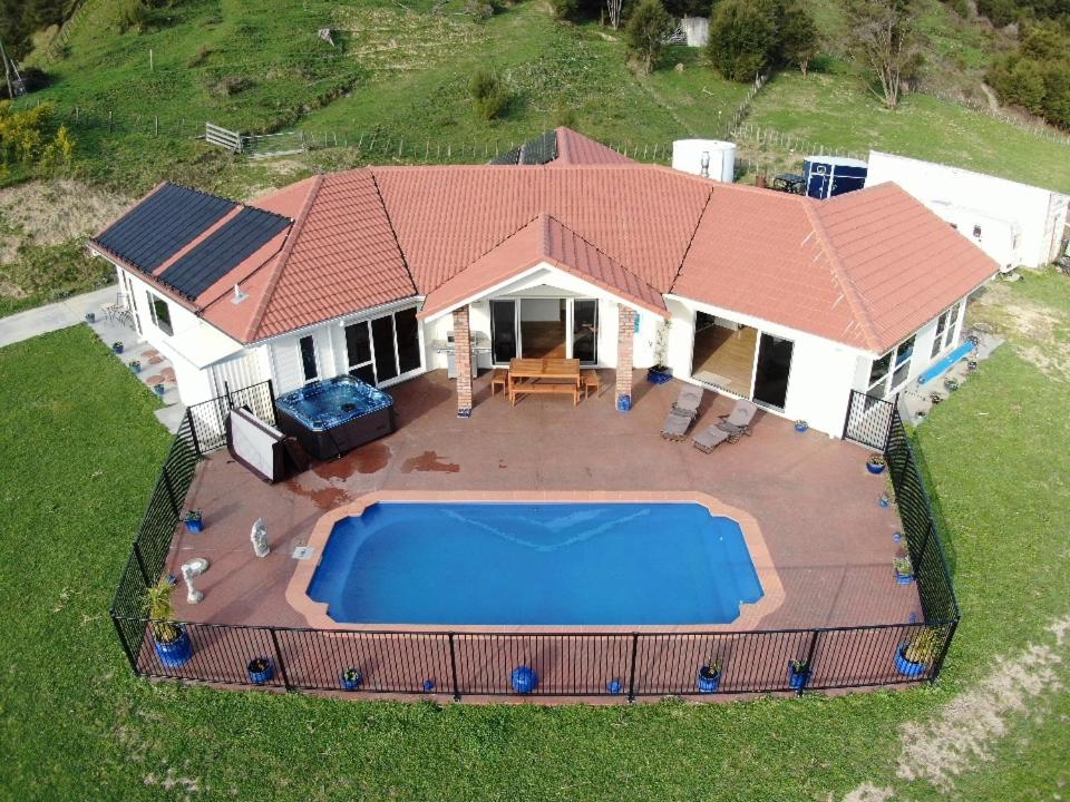an aerial view of a house with a swimming pool at Villa Shemshi in Gisborne