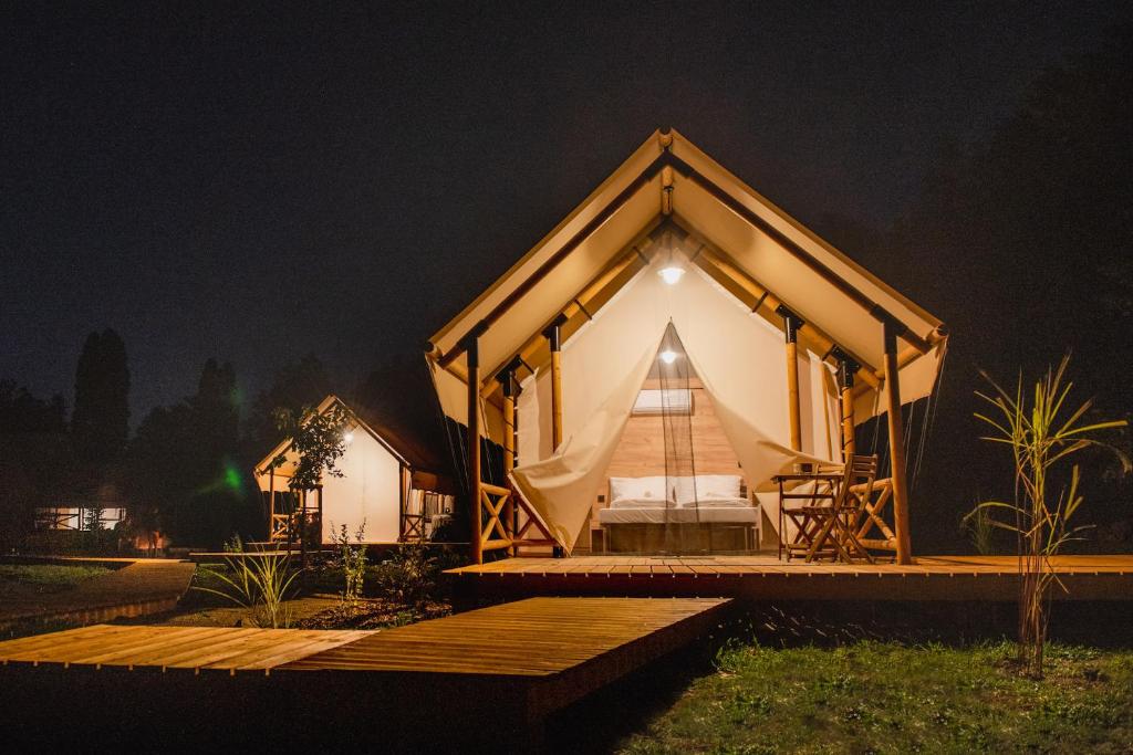a large tent with a bed in it at night at ForRest Glamping in Banská Štiavnica