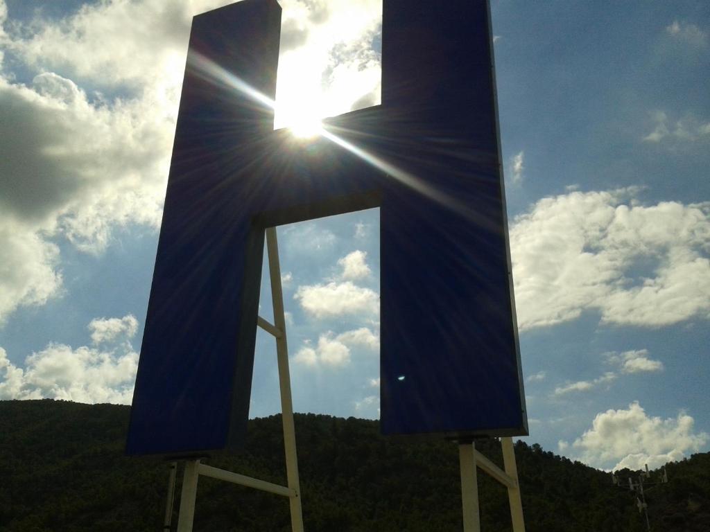 a cross with the sun in the sky at Hostal Arneva Orihuela in Arneva