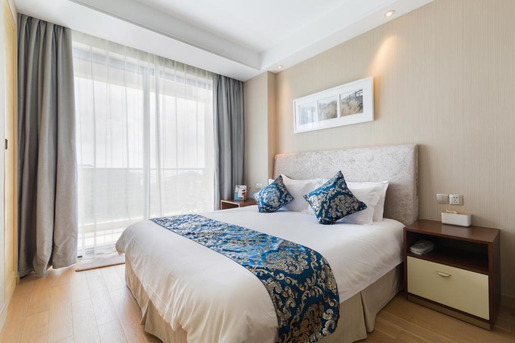 Ein Bett oder Betten in einem Zimmer der Unterkunft Pinxiayuan Apartment in Lvcheng Resort