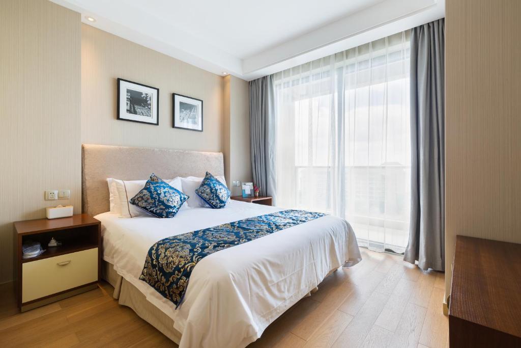 Ein Bett oder Betten in einem Zimmer der Unterkunft Pinxiayuan Apartment in Lvcheng Resort