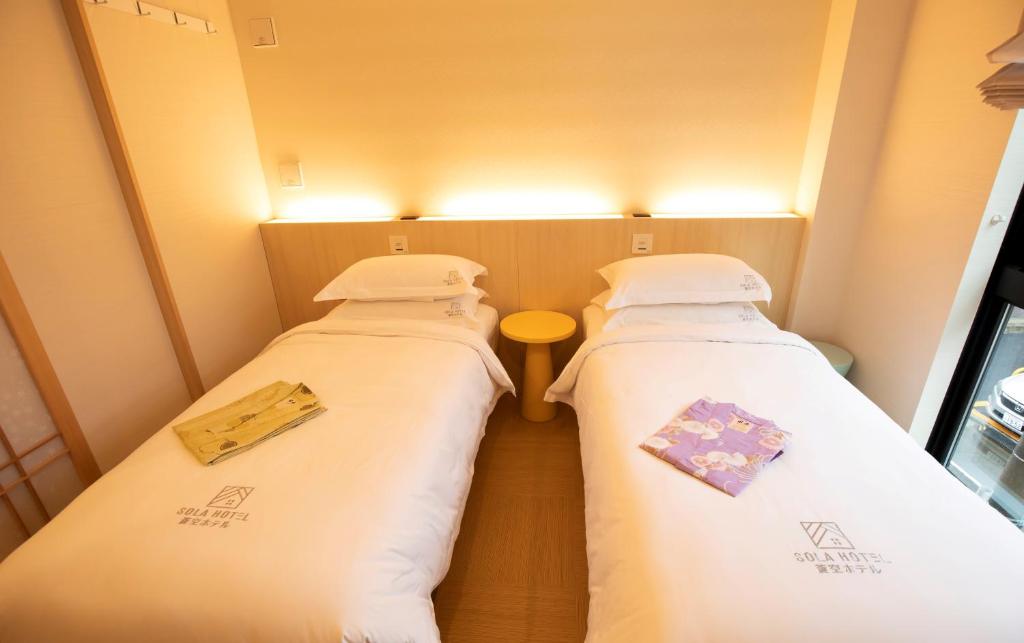 Postel nebo postele na pokoji v ubytování SOLA HOTEL